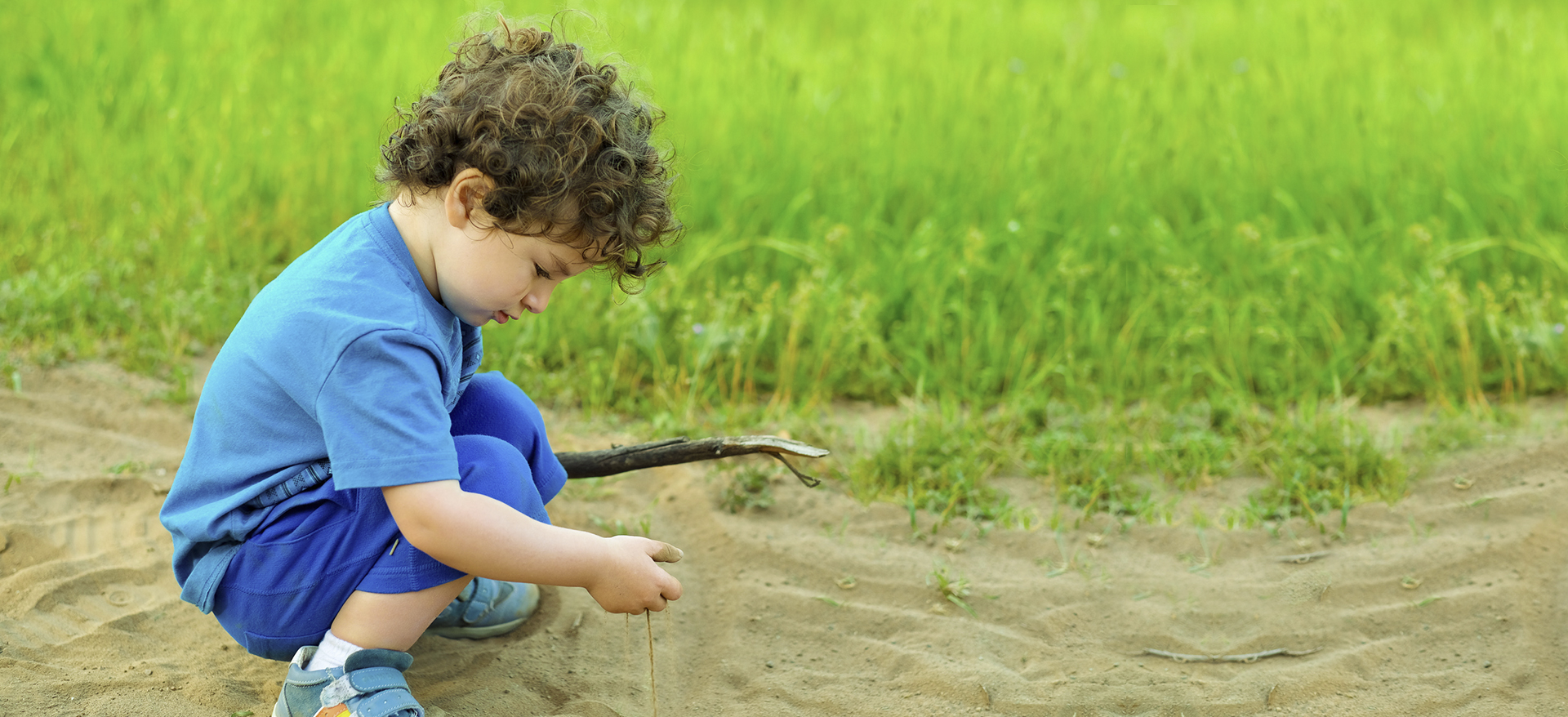 kid playing in the dirt