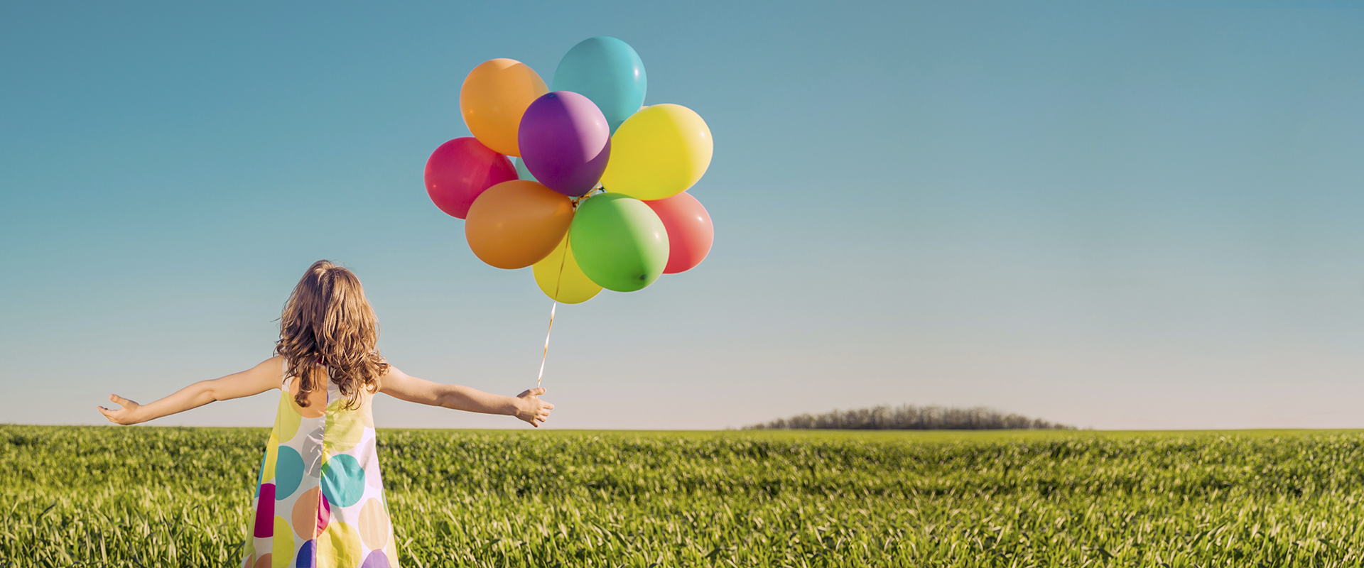 girl with baloons having fun outside